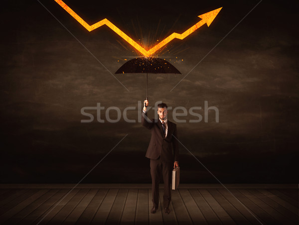 Businessman standing with umbrella keeping orange arrow  Stock photo © ra2studio