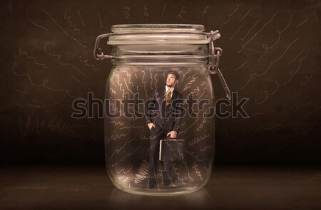 Businessman inside a jar with powerful hand drawn lines concept Stock photo © ra2studio