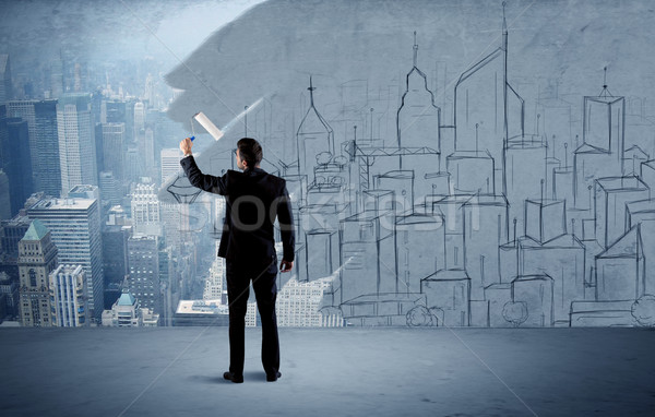 Stock photo: Elegant salesman repainting the city on wall