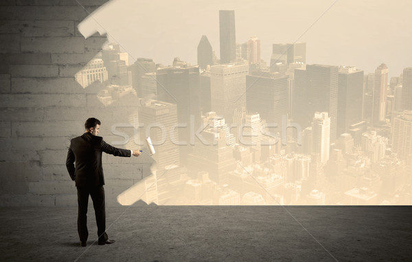 Salesman painting city scape on wall Stock photo © ra2studio