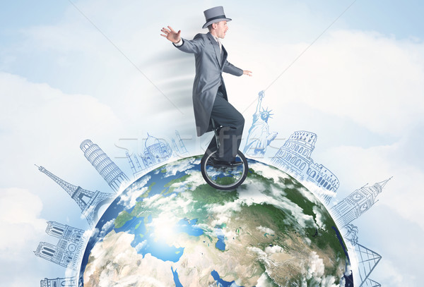 Man riding unicycle around the globe with major cities Stock photo © ra2studio