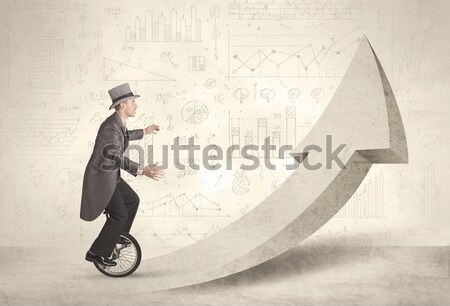 Happy business man riding a monocycle up on an arrow  Stock photo © ra2studio