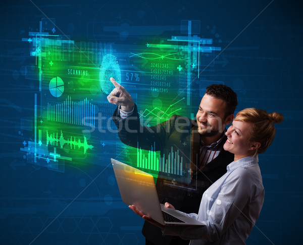 Young business couple pressing modern technology panel with fing Stock photo © ra2studio