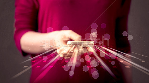 Person holding smarthphone with technology light applications Stock photo © ra2studio