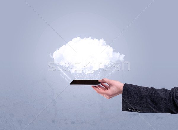 Hand holding phone with empty cloud Stock photo © ra2studio