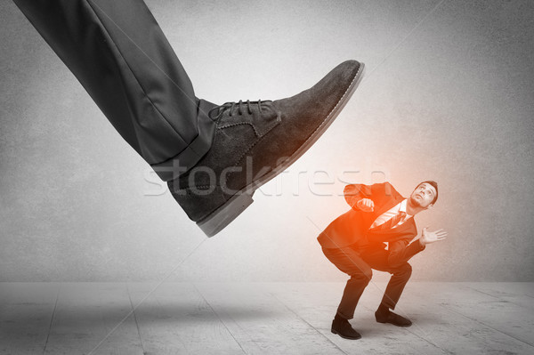 Large foot stepping down small man Stock photo © ra2studio