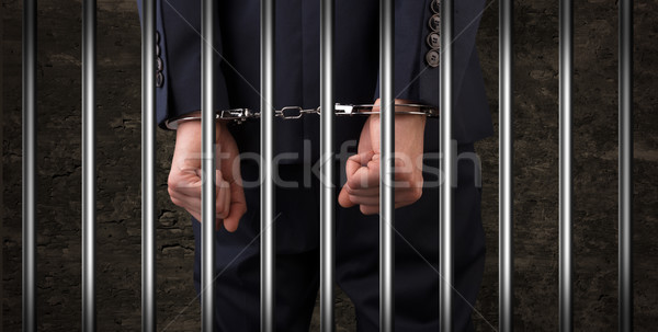 Close handcuffed man in jail Stock photo © ra2studio