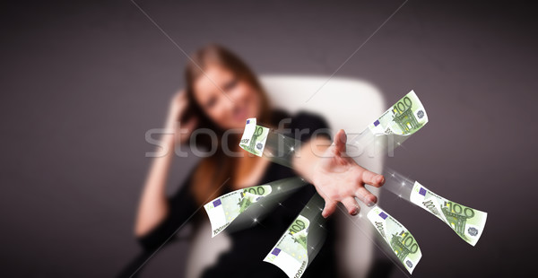 Pretty woman sitting and throwing money Stock photo © ra2studio