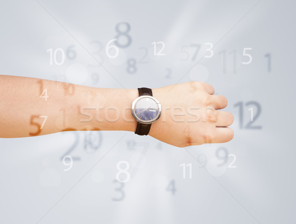 Hand with watch and numbers on the side comming out Stock photo © ra2studio