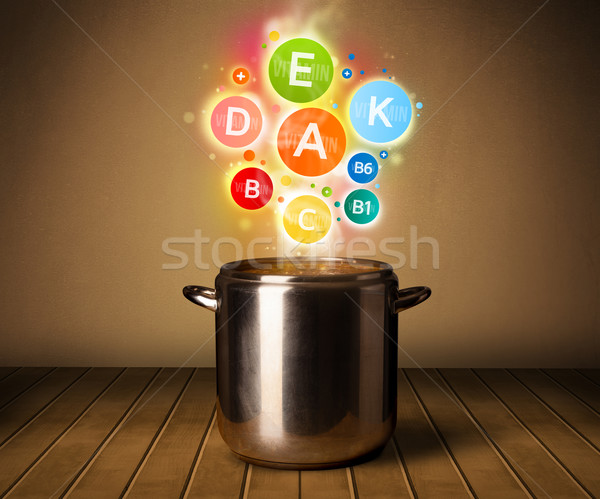 Colorful vitamins coming out from cooking pot Stock photo © ra2studio