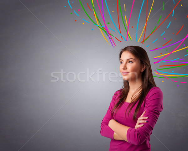 Young girl thinking with colorful abstract lines overhead Stock photo © ra2studio