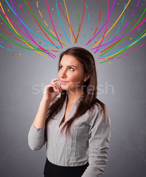 Young girl thinking with colorful abstract lines overhead Stock photo © ra2studio