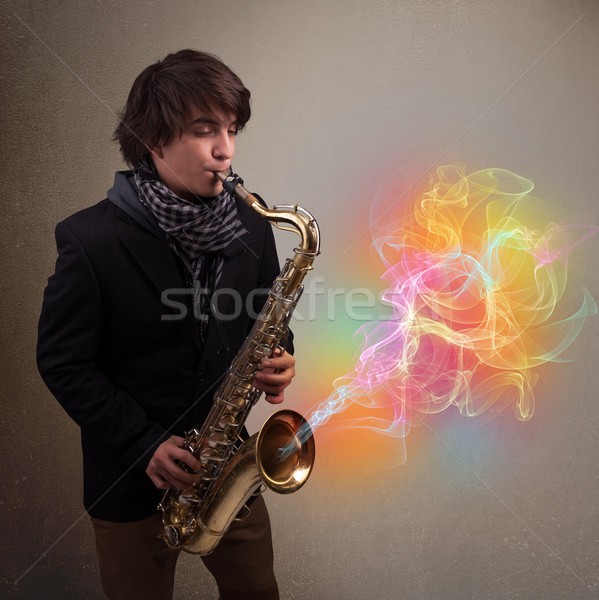 Attractive musician playing on saxophone with colorful abstract  Stock photo © ra2studio