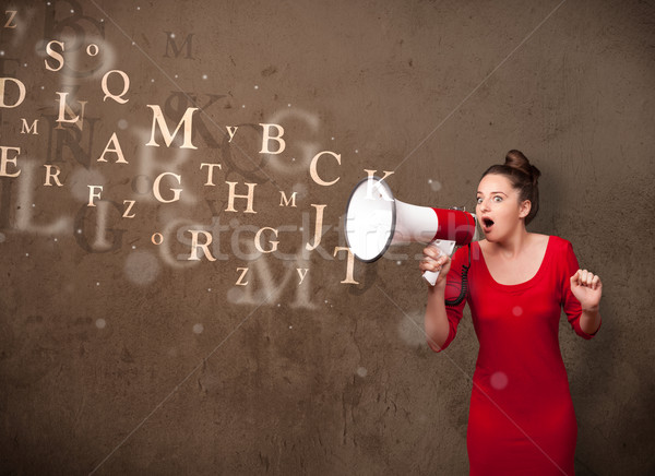 Stock photo: Young girl shouting into megaphone and text come out
