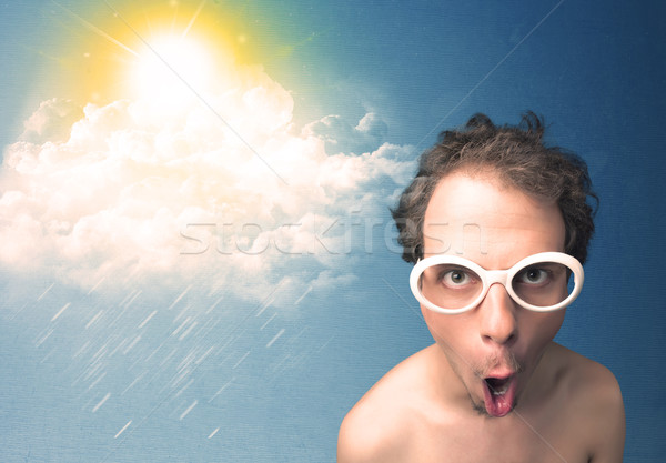 Stock photo: Young person looking with sunglasses at clouds and sun