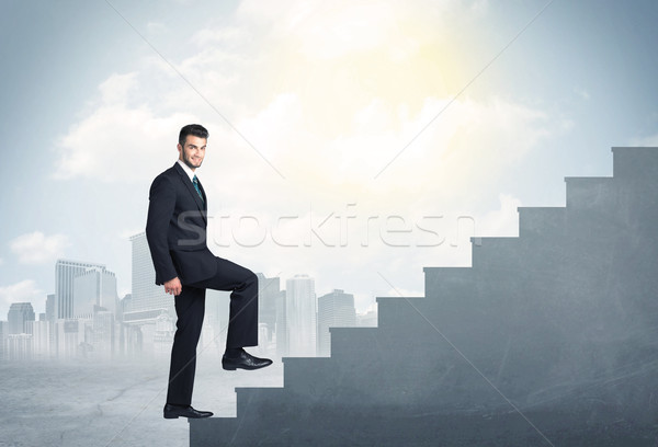 Businessman climbing up a concrete staircase concept Stock photo © ra2studio