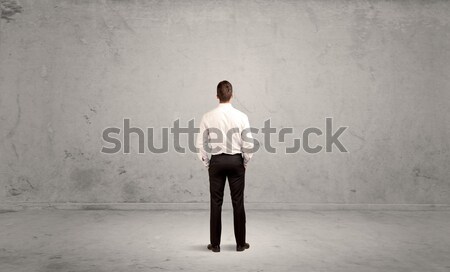 Young businessman standing confused Stock photo © ra2studio