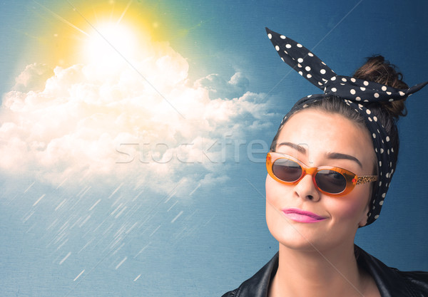 Young person looking with sunglasses at clouds and sun Stock photo © ra2studio