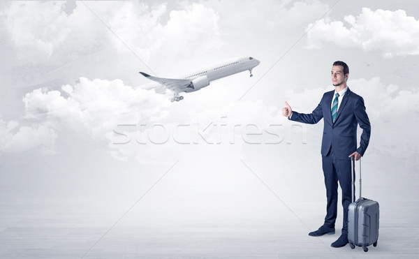 Agent hitchhiking with departing plane concept Stock photo © ra2studio