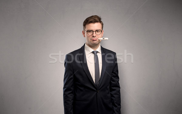 Businessman with thermometer and copy space Stock photo © ra2studio