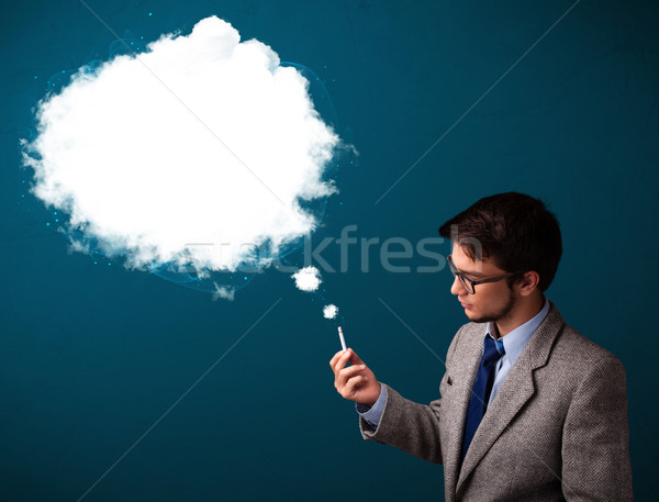 Young man smoking unhealthy cigarette with dense smoke Stock photo © ra2studio