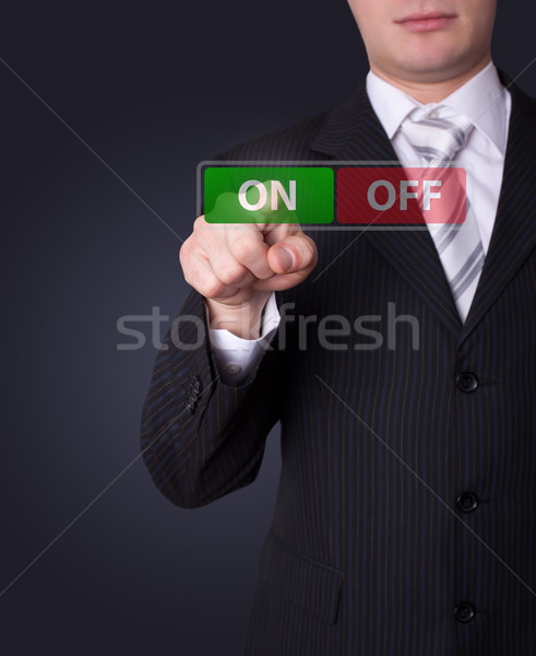 Man pressing ON / OFF button Stock photo © ra2studio
