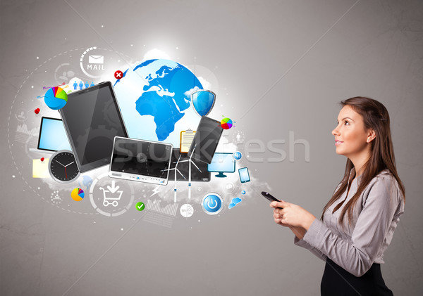 young woman standing and browsing on her phone Stock photo © ra2studio