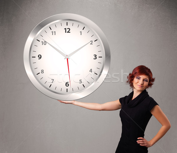 Attractive lady holding a huge clock Stock photo © ra2studio