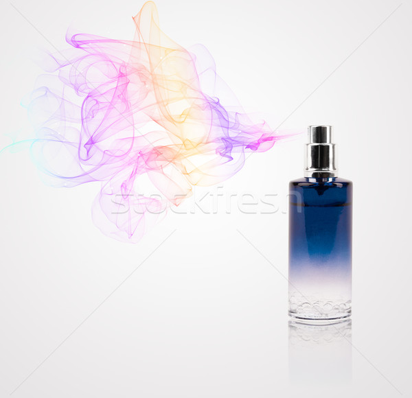 Perfume bottle spraying colored scent Stock photo © ra2studio