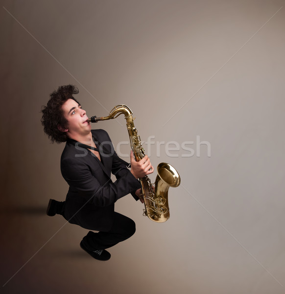 Young musician playing on saxophone Stock photo © ra2studio