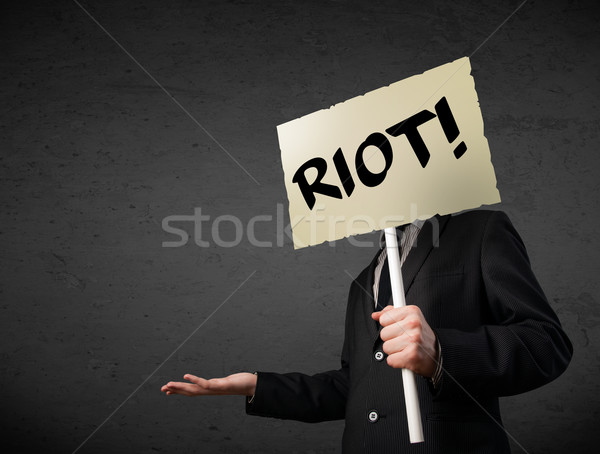 Businessman holding a protest sign Stock photo © ra2studio