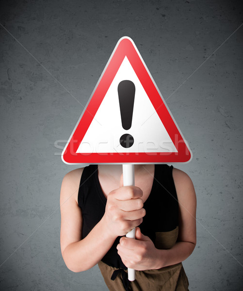 Young woman holding an exclamation road sign Stock photo © ra2studio