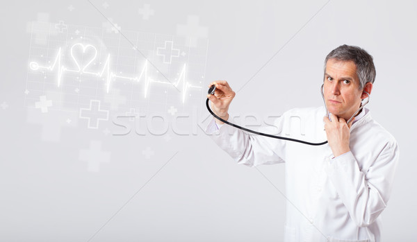 Doctor examinates heartbeat with abstract heart Stock photo © ra2studio