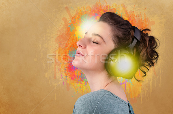 Young woman with headphones listening to music Stock photo © ra2studio