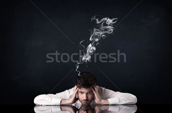Depressed businessman with smoking head Stock photo © ra2studio