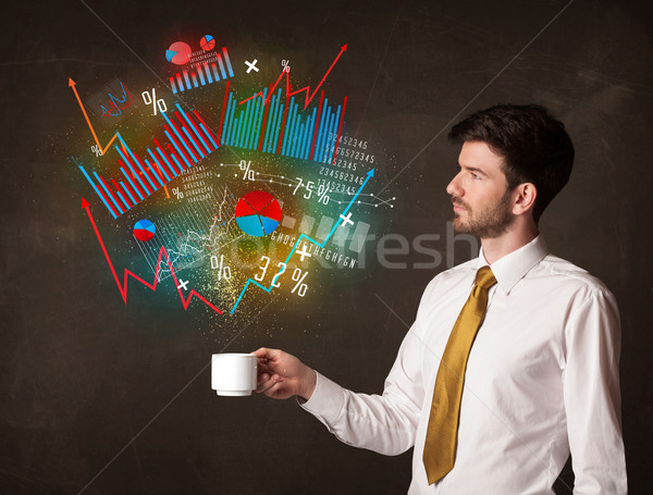 Businessman holding a white cup with diagrams and graphs Stock photo © ra2studio