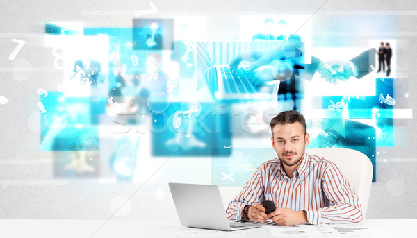 Business person at desk with modern tech images at background Stock photo © ra2studio