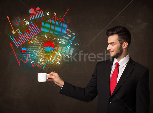 Businessman holding a white cup with diagrams and graphs Stock photo © ra2studio