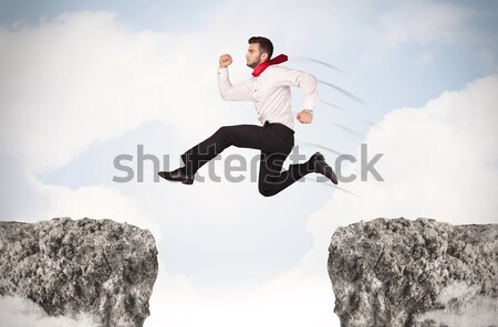 смешные деловой человек прыжки пород разрыв бизнеса Сток-фото © ra2studio