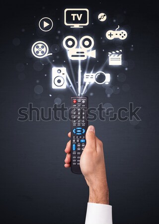 Hand with remote control and curly lines Stock photo © ra2studio