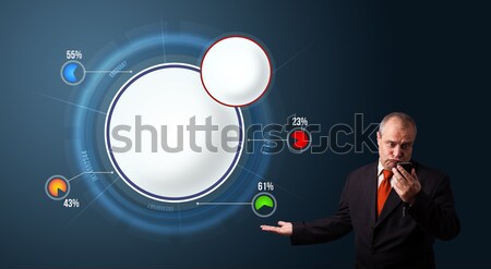 crazy businessman in suit holding a phone and presenting abstract modern pie chart Stock photo © ra2studio