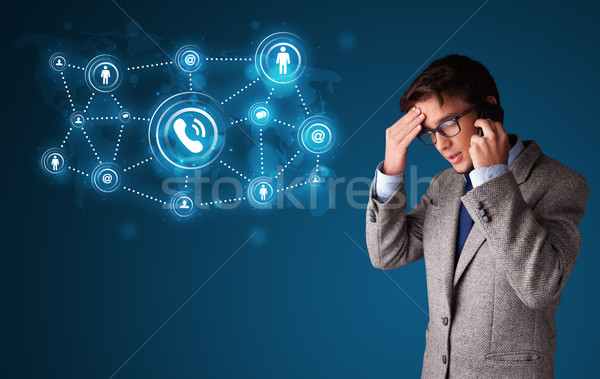 Fiatal srác készít telefonbeszélgetés közösségi háló ikonok áll Stock fotó © ra2studio