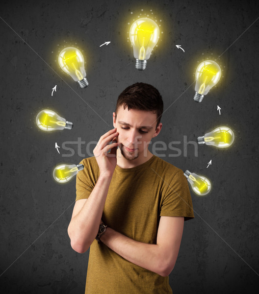 Young man thinking with lightbulb circulation around his head Stock photo © ra2studio