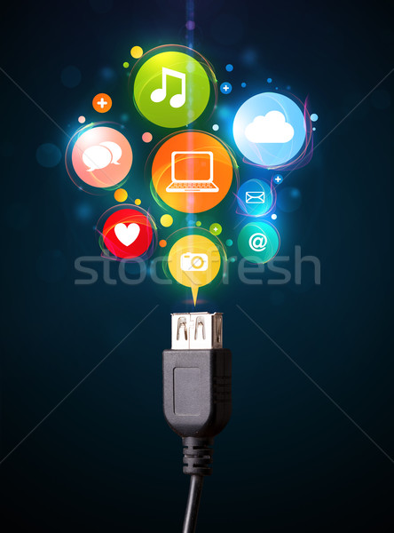 Social media icons coming out of electric cable Stock photo © ra2studio