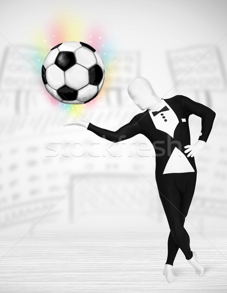 man in full body suit holdig soccer ball Stock photo © ra2studio