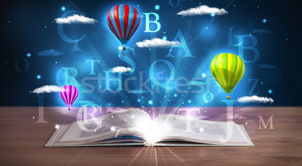 Stock photo: Open book with glowing fantasy abstract clouds and balloons