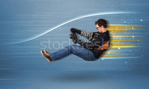 Młody człowiek jazdy wyimaginowany szybko samochodu zamazany Zdjęcia stock © ra2studio