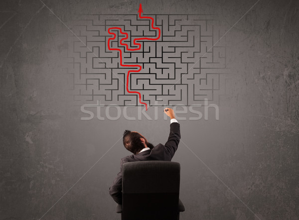 Business man looking at a maze and the way out  Stock photo © ra2studio