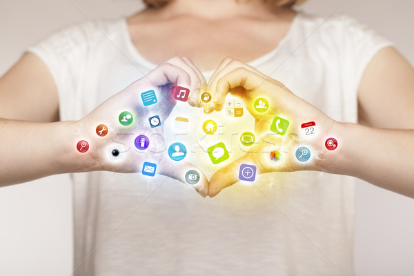 Stock photo: Hands creating a form with mobile app icons