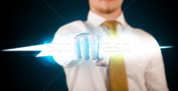 Business man holding glowing lightning bolt in his hands Stock photo © ra2studio